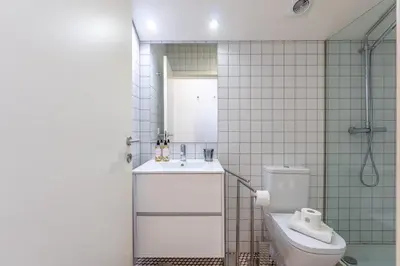 a bathroom with a toilet and a sink and a shower at Catedral da Sé Apartment in Porto