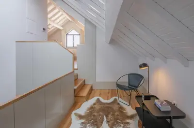 a living room with a table and a chair at Rua Formosa 99 in Porto