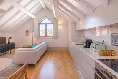 a kitchen and living room with a couch and a table at Rua Formosa 99 in Porto