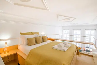 a bedroom with a bed with towels on it at Mouzinho Hill View in Porto