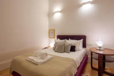 a bedroom with a bed with towels on it at Mouzinho Hill View in Porto