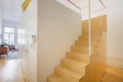 a staircase in a house with a glass wall at Mouzinho Hill View in Porto
