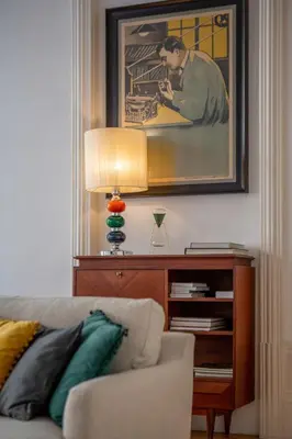 a living room with a couch and a table with a lamp at Mouzinho Hill View in Porto