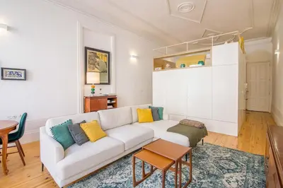 a living room with a white couch and a table at Mouzinho Hill View in Porto