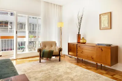a living room with a chair and a dresser at VIVA Cozy Downtown in Porto