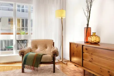 a living room with a chair and a dresser at VIVA Cozy Downtown in Porto