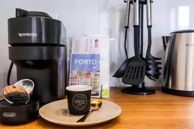 a coffee maker and a cup on a table at River Corticeira II in Porto