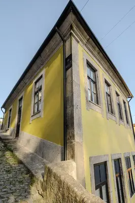 a yellow building with windows on the side of it at River Sight Corticeira III in Porto