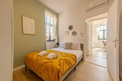 a bedroom with a bed with an orange blanket at River Sight Corticeira III in Porto