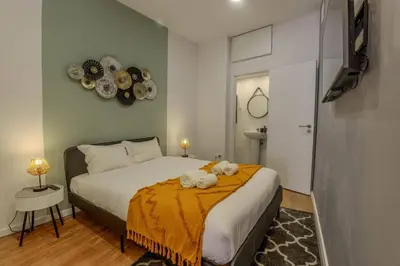 a bedroom with a bed with two towels on it at River Corticeira I in Porto