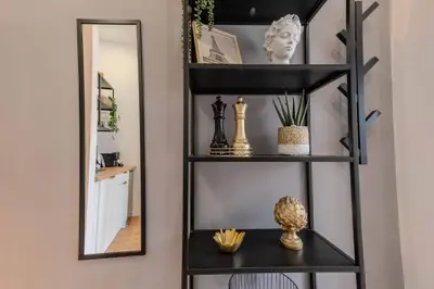 a black shelf in a room with a mirror at River Corticeira I in Porto