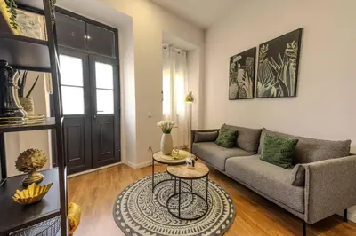 a living room with a couch and a table at River Corticeira I in Porto