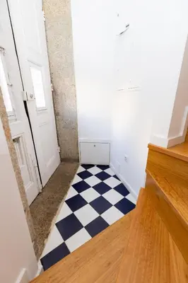 a hallway with a black and white checkered floor at Trindade Trendy Studio 17 in Porto