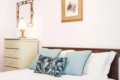a bedroom with a bed with blue and white pillows at GuestReady - Eclectic haven in the heart of Porto in Porto