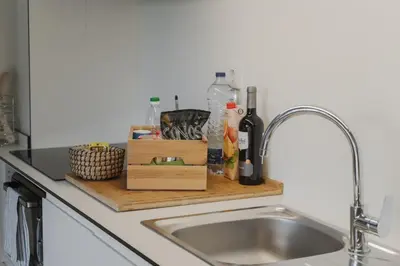 a kitchen counter with a sink and a cutting board at Loveporto Varanda Jardim Centro in Porto