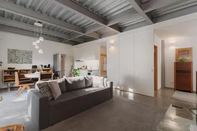 a living room with a couch and a kitchen at Loveporto Varanda Jardim Centro in Porto