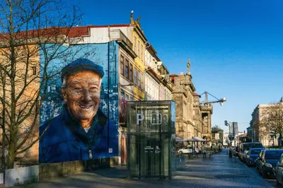 a large clock tower in a city with a street at Loveporto Varanda Jardim Centro in Porto
