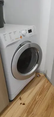 a white washing machine sitting on top of a wooden floor at Ribeira Riverview Panoramic in Porto