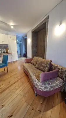 a couch in a living room with a wooden floor at Ribeira Riverview Panoramic in Porto