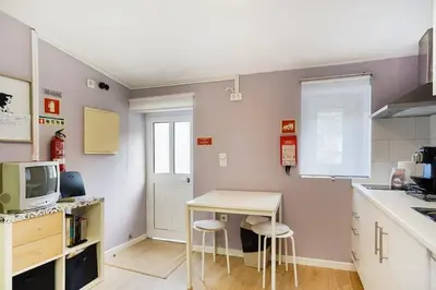 a small kitchen with a table and chairs in it at Island House in Porto