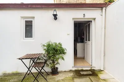a door to a white house with a table and a plant at Island House in Porto