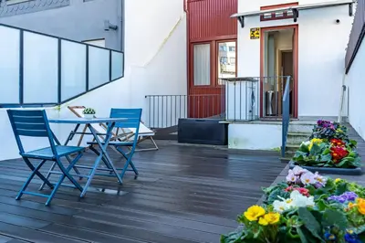 a patio with two chairs and a table and flowers at Intimate Apartment Downtown With Terrace - D in Porto