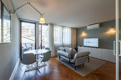 a living room with a couch and a tv at Oporto Chic and Glamorous Downtown with Terrace-F in Porto
