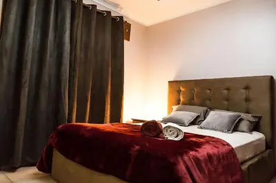 a bedroom with a large bed with a red blanket at Gaia Riverview in Vila Nova de Gaia