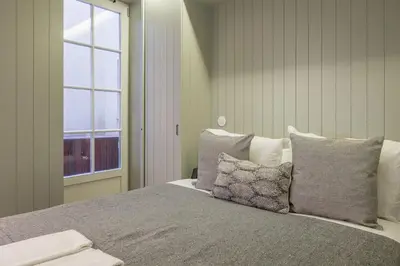 a bedroom with a bed with pillows and a window at Pleasant Studio Santa Catarina in Porto