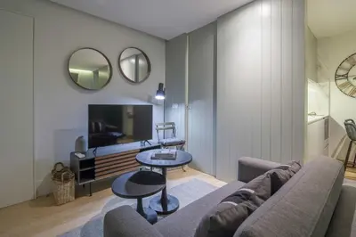 a living room with a couch and a table at Pleasant Studio Santa Catarina in Porto