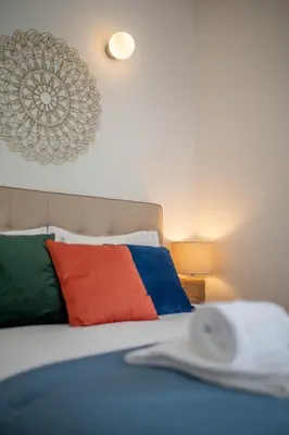 a bedroom with a bed with colorful pillows at PS70 Apartments I in Porto