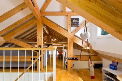 a room with a loft with wooden ceilings at Ribeira Memories 72 in Porto