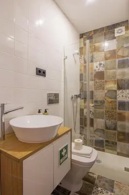 a bathroom with a sink and a toilet and a shower at Tailor's Apartments II in Porto