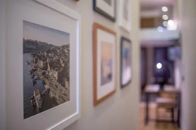 a picture hanging on a wall with pictures on it at Tailor's Apartments II in Porto