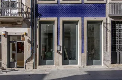 a row of glass doors on a building at Topo Flores Apartment in Porto