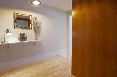 a room with a mirror and a vase on a shelf at Virginie Almada Apartment in Porto