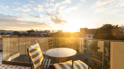 a view of a balcony with a table and chairs at New 3BR w Rooftop & Balcony Views by LovelyStay in Porto