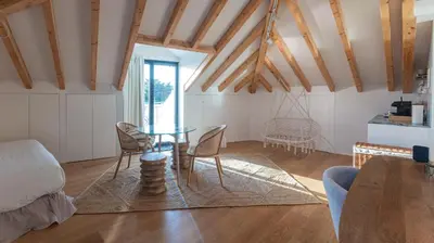 a living room with a table and chairs at New 3BR w Rooftop & Balcony Views by LovelyStay in Porto