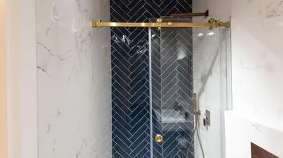a bathroom with a shower with blue and white tiles at New 3BR w Rooftop & Balcony Views by LovelyStay in Porto