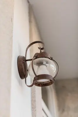 an old metal light on the side of a door at Downtown Urban Nest in Porto