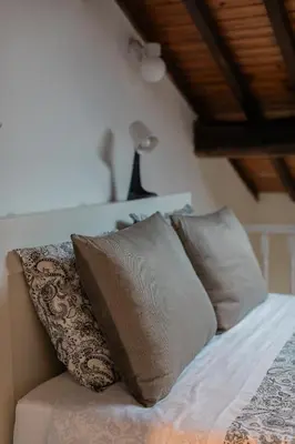 a bed with four pillows and a lamp on it at Downtown Urban Nest in Porto