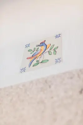 a card with a bird on a branch with blue flowers at Downtown Urban Nest in Porto