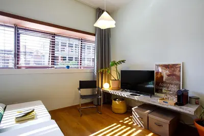 a room with a bed and a desk and a kitchen at Casa Agustina, Central and sunny Studio with optional Parking in Porto