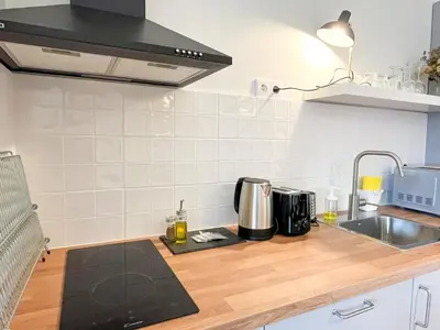 a kitchen with a sink and a counter top at Casa Agustina, Central and sunny Studio with optional Parking in Porto
