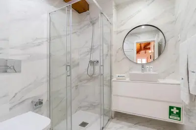 a bathroom with a shower and a sink and a mirror at HostWise - Stylish Retreat in Porto's Heart in Porto