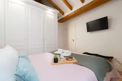 a bedroom with a bed with a tray on it at HostWise - Stylish Retreat in Porto's Heart in Porto