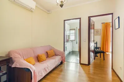 a living room with a couch and a table at GuestReady - Bonfim Cozy Retreat in Porto