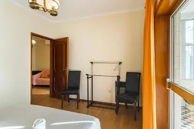a room with two chairs and a bed and a mirror at GuestReady - Bonfim Cozy Retreat in Porto
