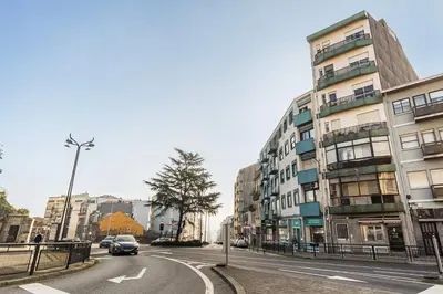 a car driving down a city street with buildings at GuestReady - Bonfim Cozy Retreat in Porto