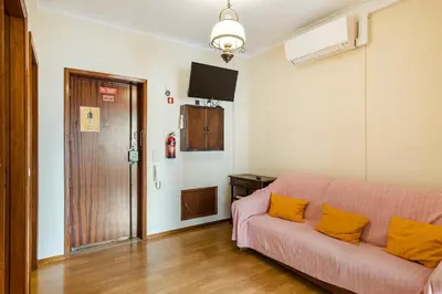 a living room with a couch and a television at GuestReady - Bonfim Cozy Retreat in Porto